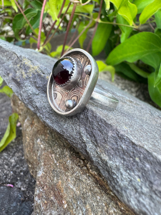 Handmade sterling silver garnet ring with Mokume Gane band, alternate view