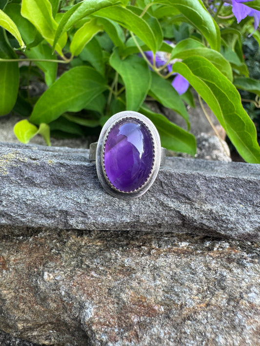 Handmade sterling silver large amethyst ring with serrated bezel and wide band, front view