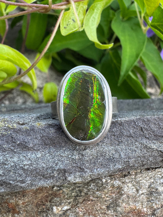 Handmade sterling silver green flash ammolite ring, front view