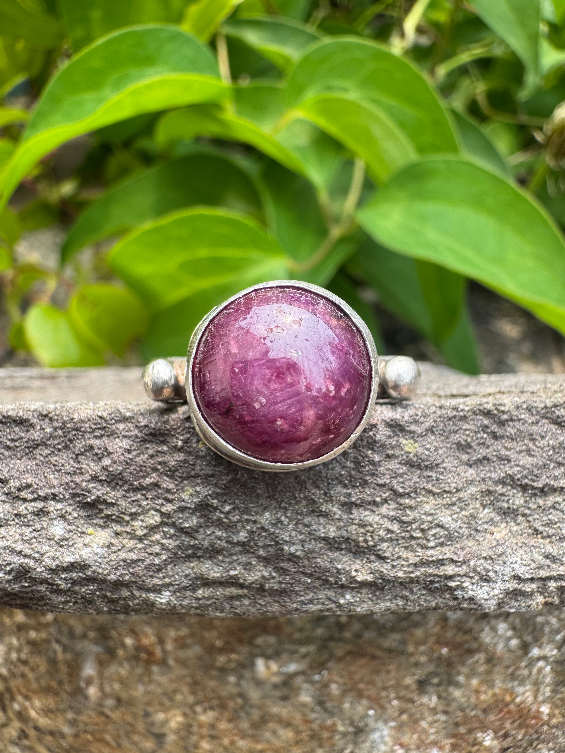 Handmade sterling silver faceted ruby round ring, front view