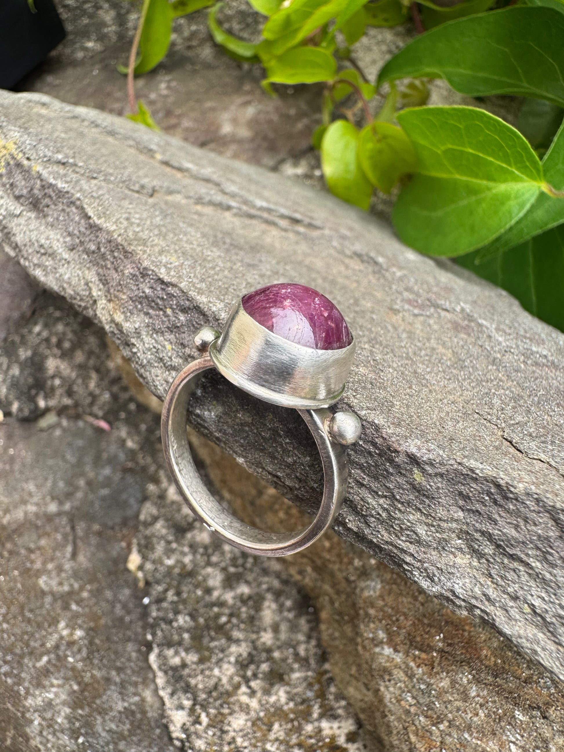 Handmade sterling silver faceted ruby round ring, close-up view
