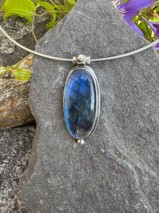 Handmade sterling silver elongated labradorite oval pendant, front view