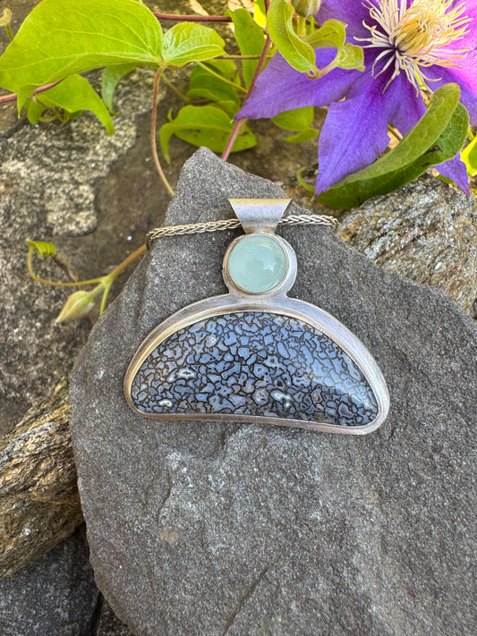 Handmade sterling silver fossil dinosaur bone and aquamarine crescent pendant, front view