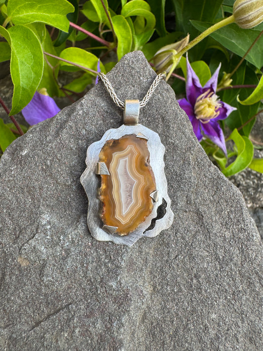 Handmade sterling silver freeform crazy lace agate pendant, front view