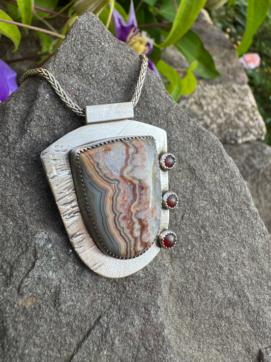 Handmade sterling silver shield-cut crazy lace agate pendant with garnets, alternate view