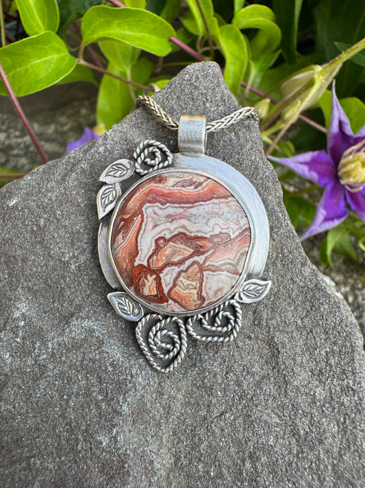 Handmade sterling silver crazy lace agate pendant in ornate sterling silver frame, front view