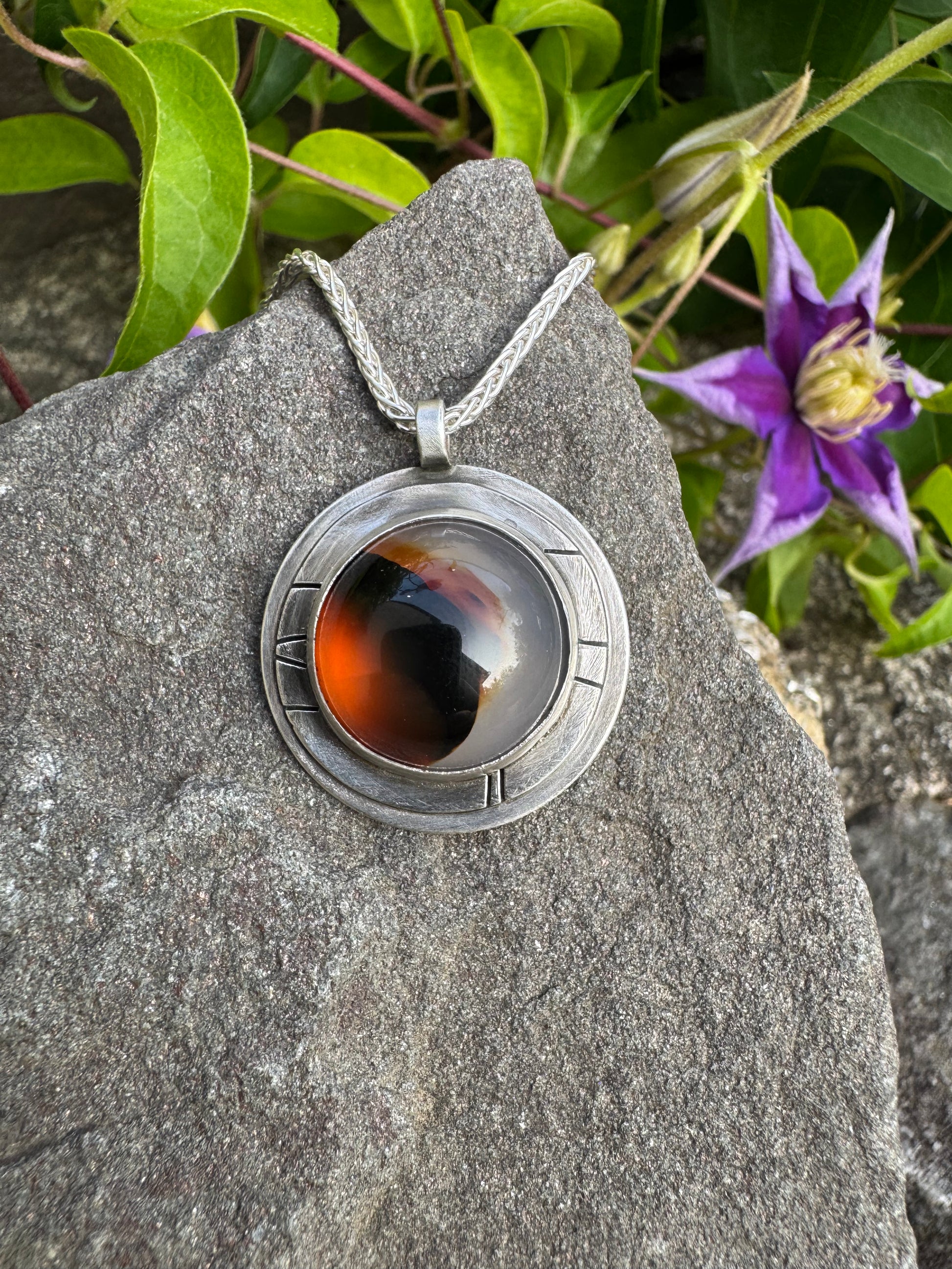 Handmade sterling silver Montana agate pendant in sterling silver with engraved panels, front view