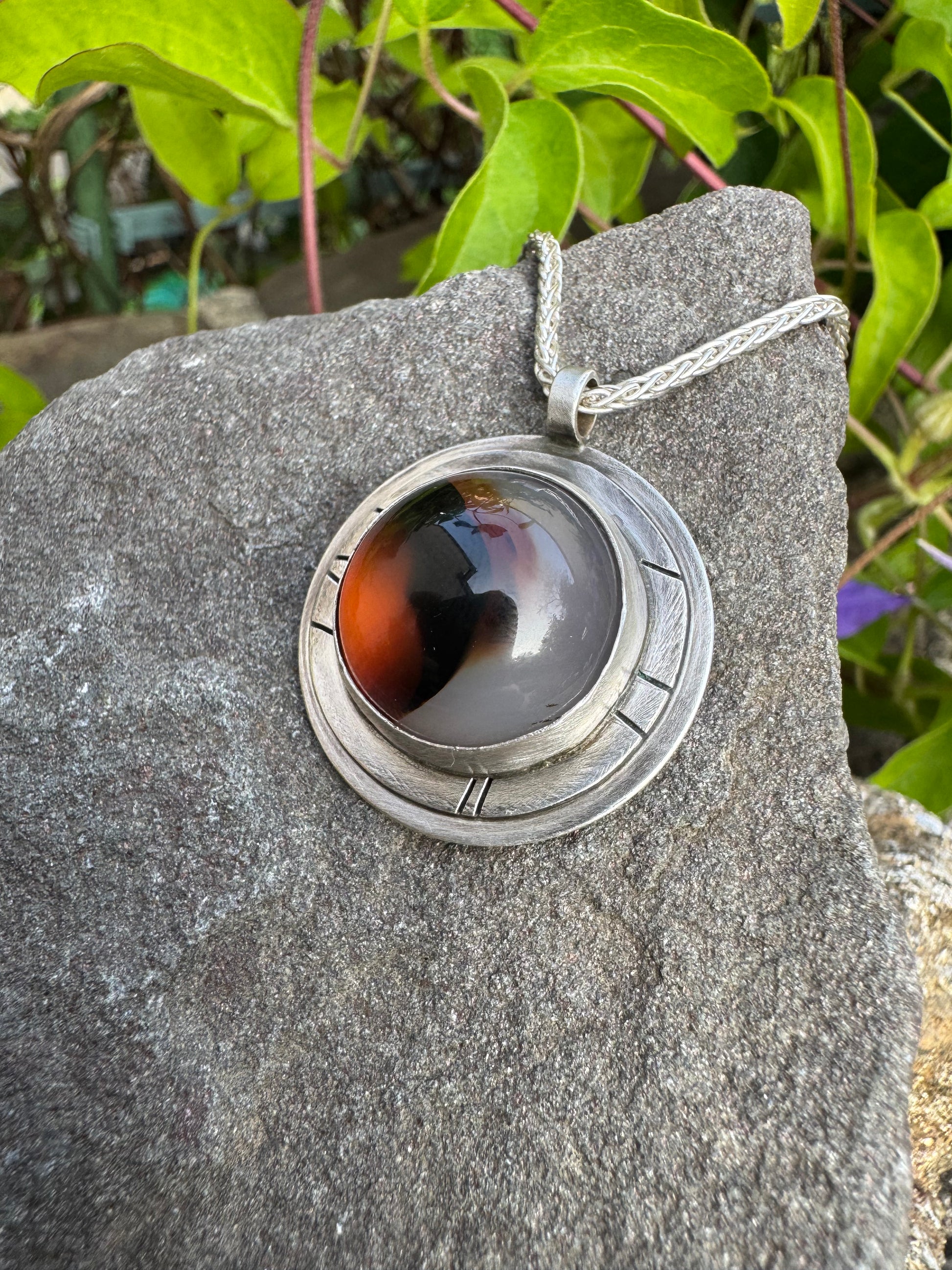 Handmade sterling silver Montana agate pendant in sterling silver with engraved panels, detail view