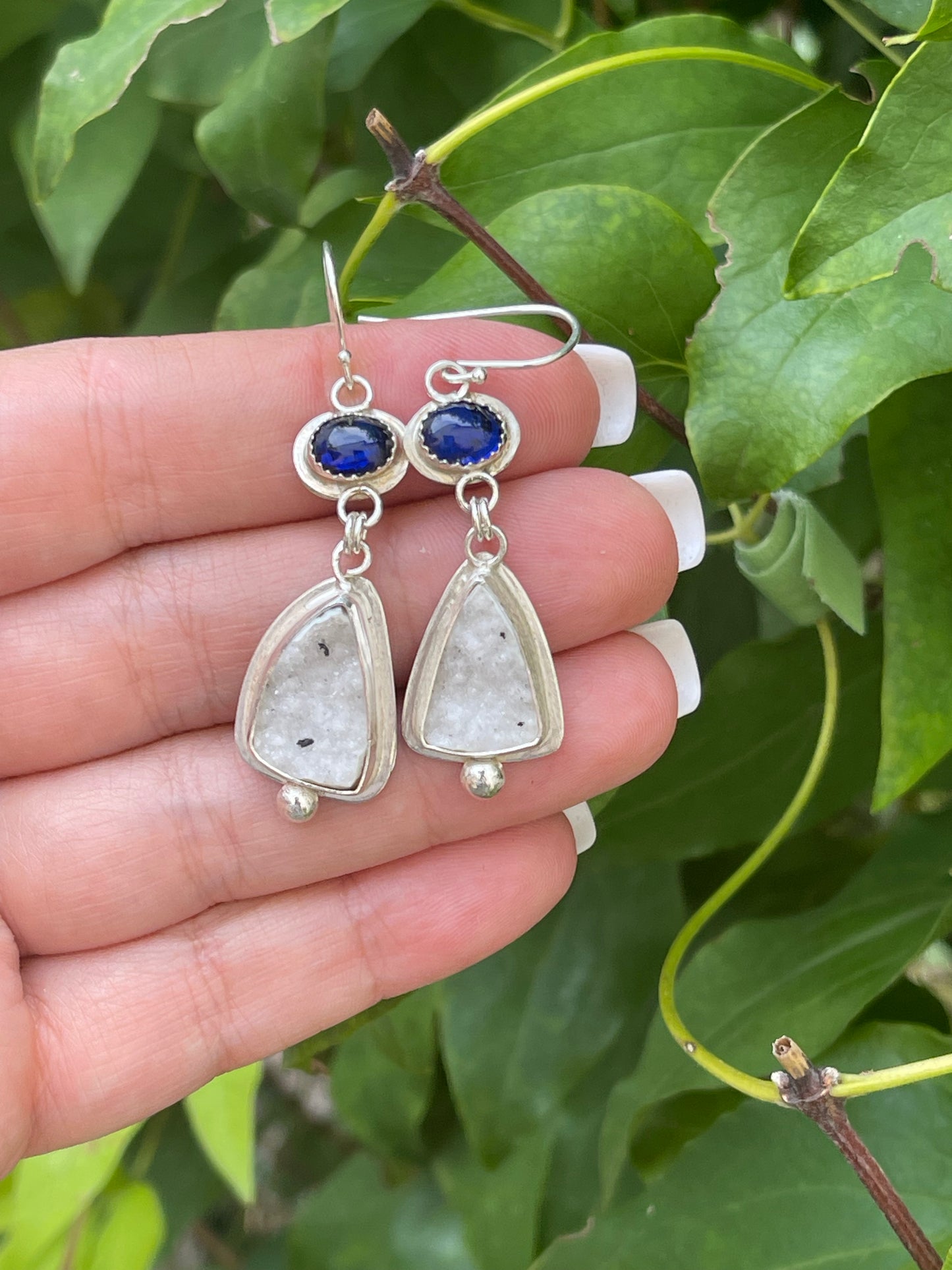 Silver earrings with royal blue oval sapphires above soft white druzy drops