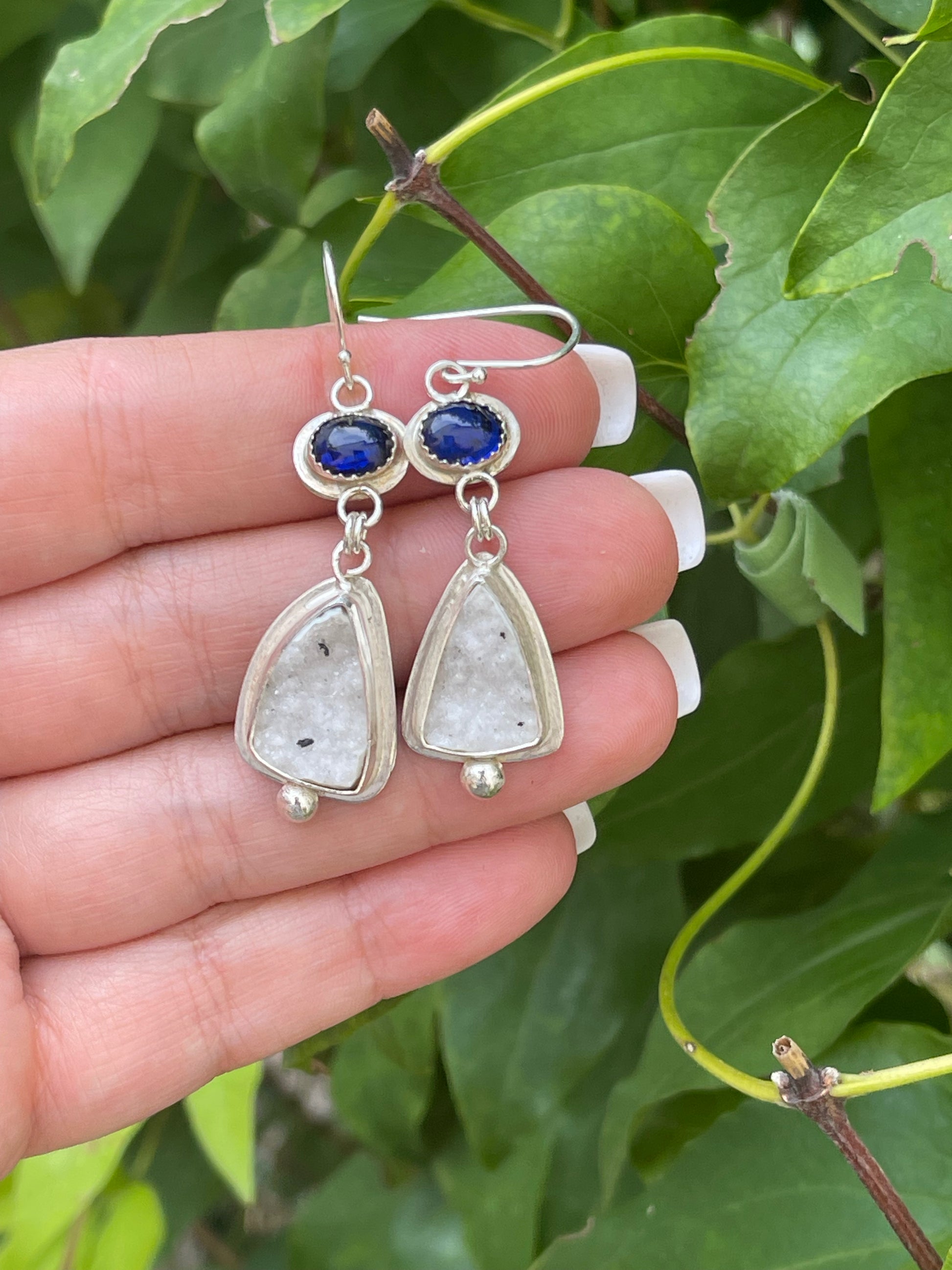 Silver earrings with royal blue oval sapphires above soft white druzy drops