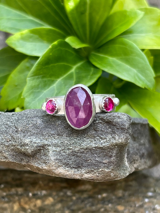 Handmade sterling silver ruby and pink topaz three-stone ring, front view