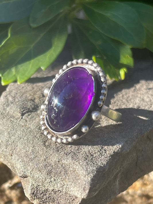 Handmade sterling silver deep amethyst ring with serrated bezel, front view