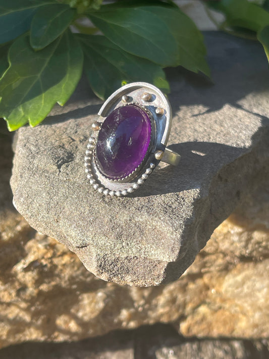 Handmade sterling silver amethyst ring with serrated bezel, front view